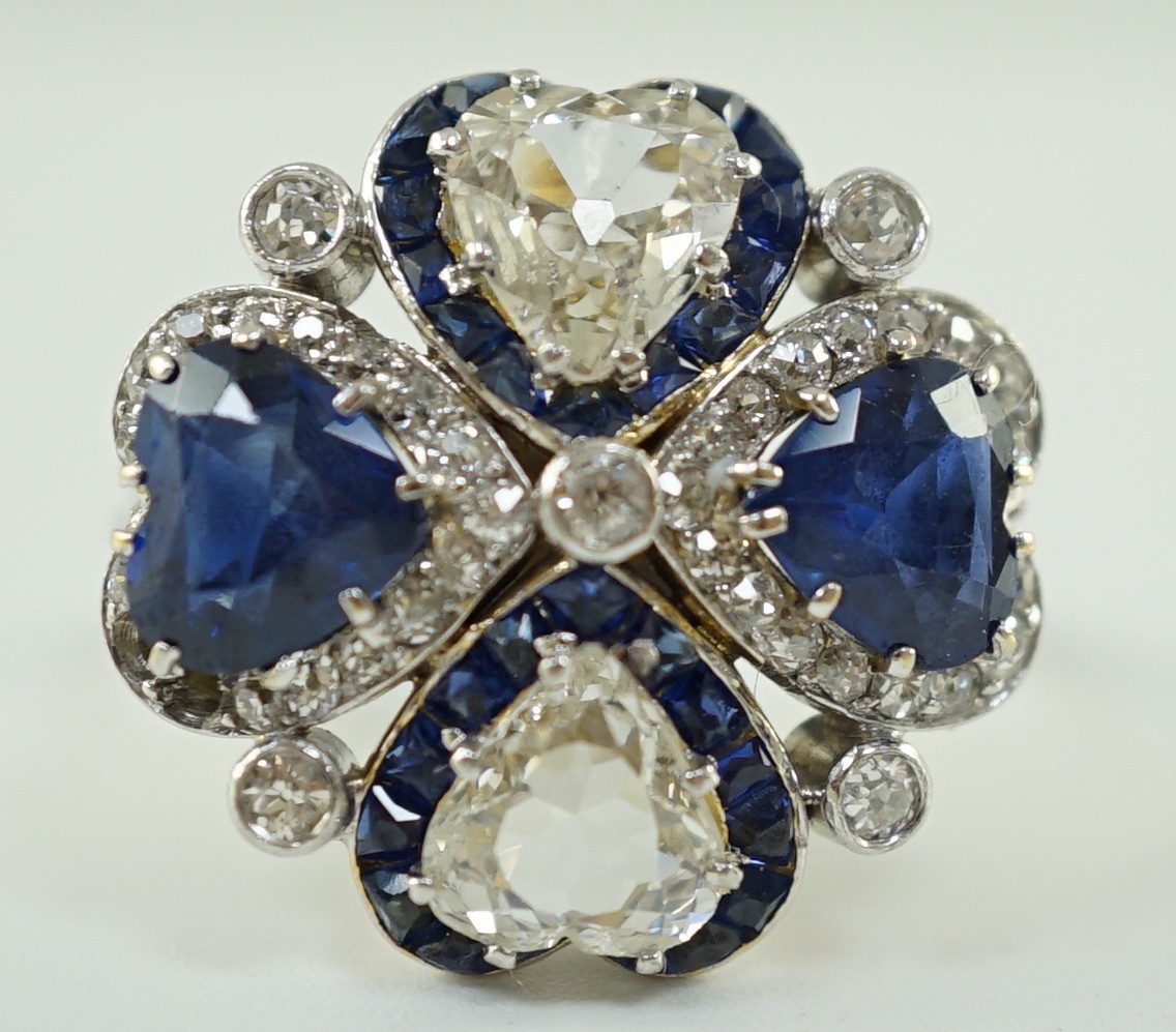 An attractive 18ct white gold, two stone heart shaped diamond and two stone heart shaped sapphire set cluster ring